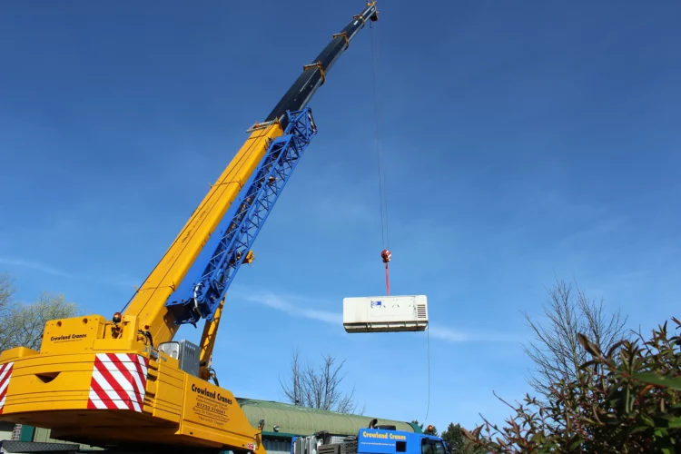 Crane lifting generator in mid air