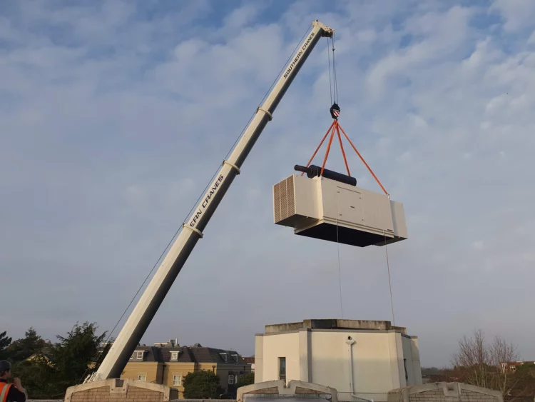 Crane lifting generator in mid air